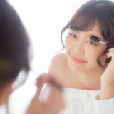 Beautiful young asian woman applying makeup eyebrows brush, beau